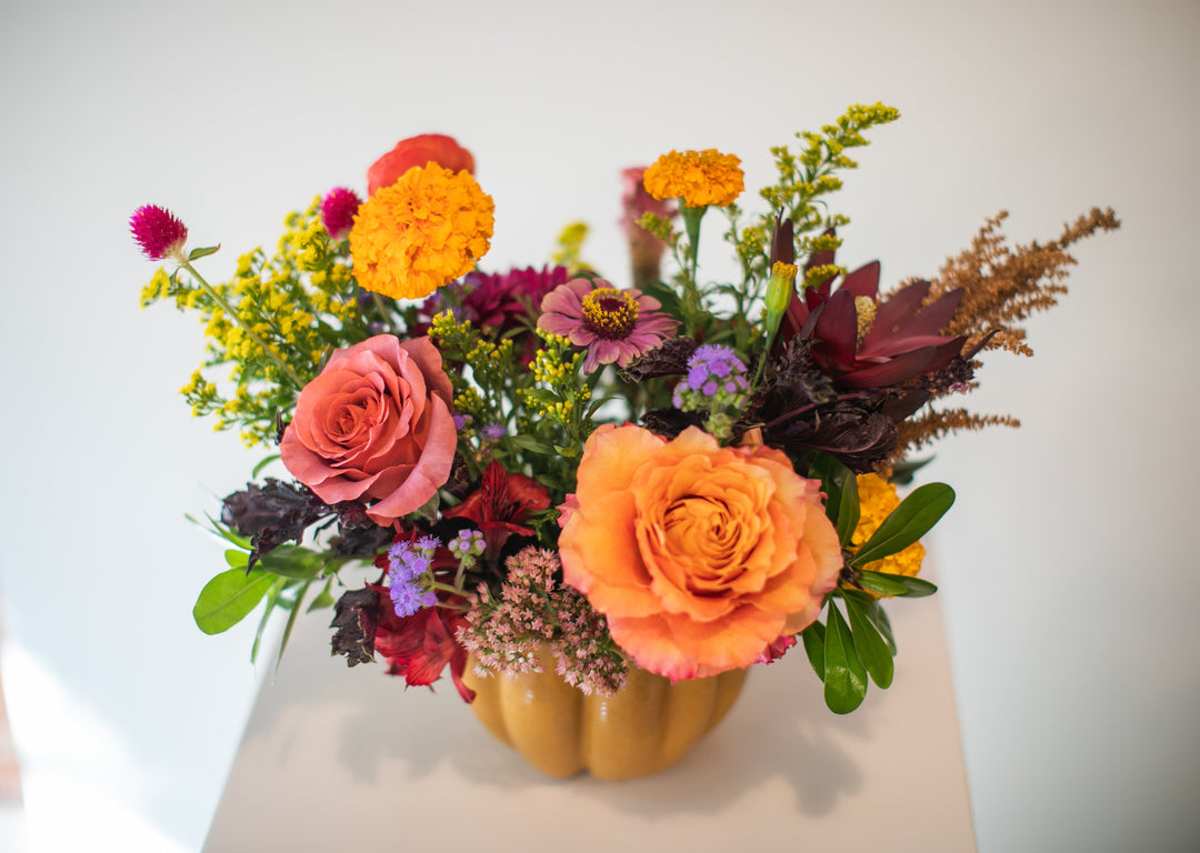 Colorful floral arrangement in a pumpkin-shaped vase Kansas City delivery Thanksgiving Fall flowers