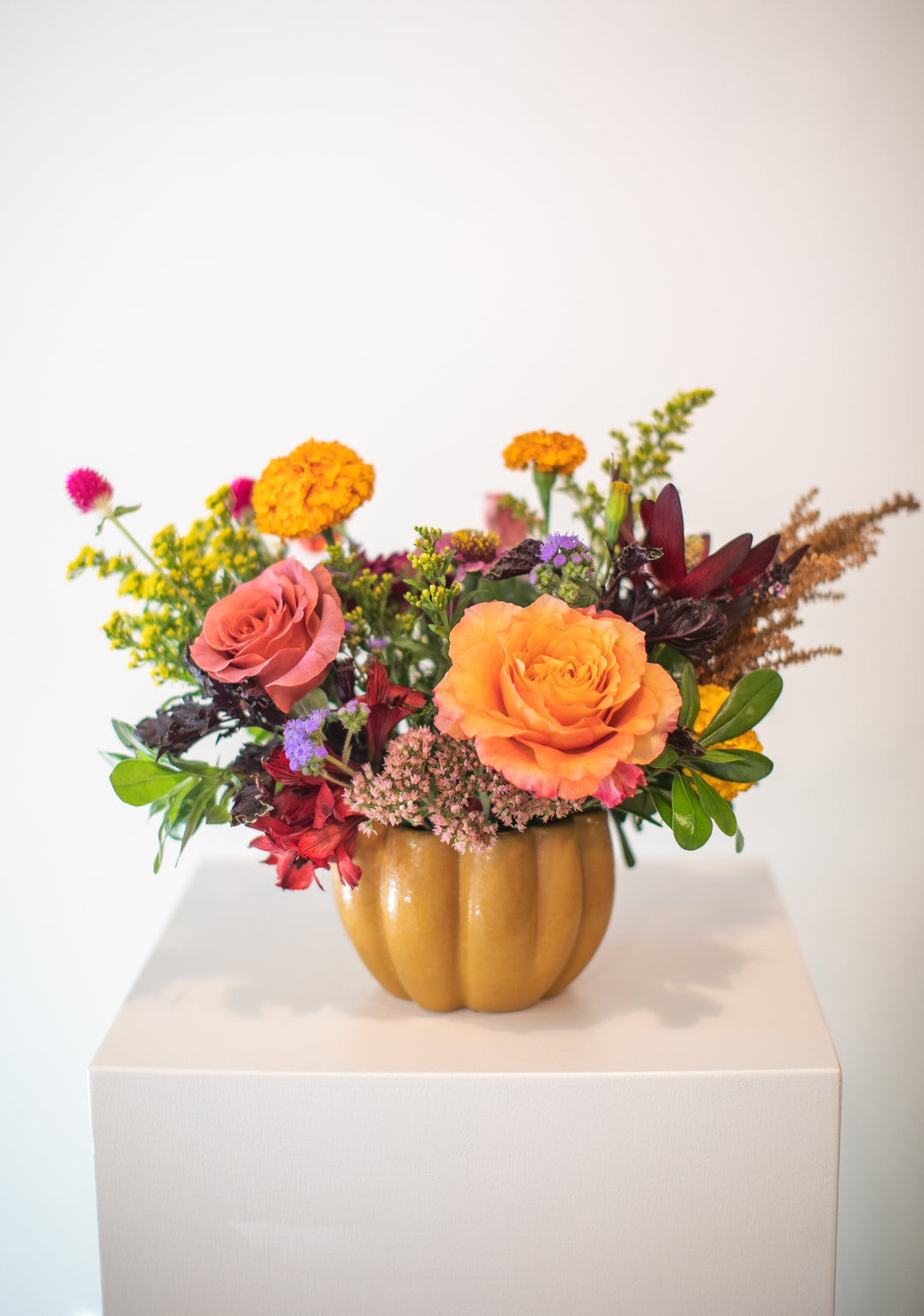 Colorful floral arrangement in a pumpkin-shaped vase Kansas City delivery Thanksgiving Fall flowers