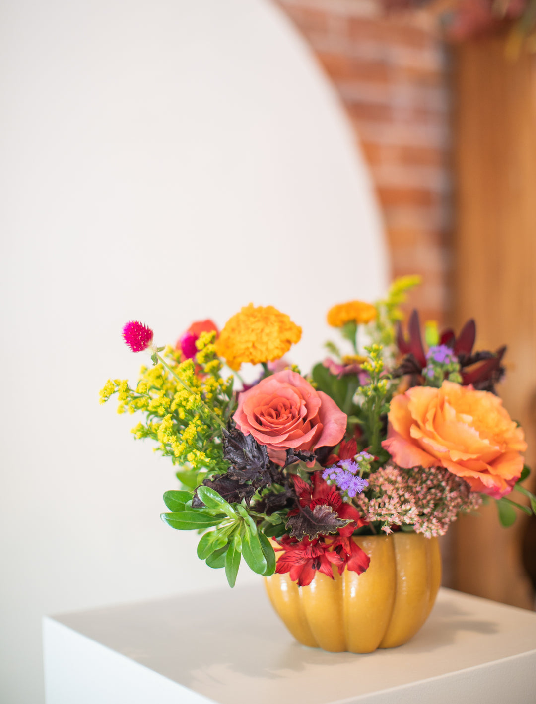 Colorful floral arrangement in a pumpkin-shaped vase Kansas City delivery Thanksgiving Fall flowers