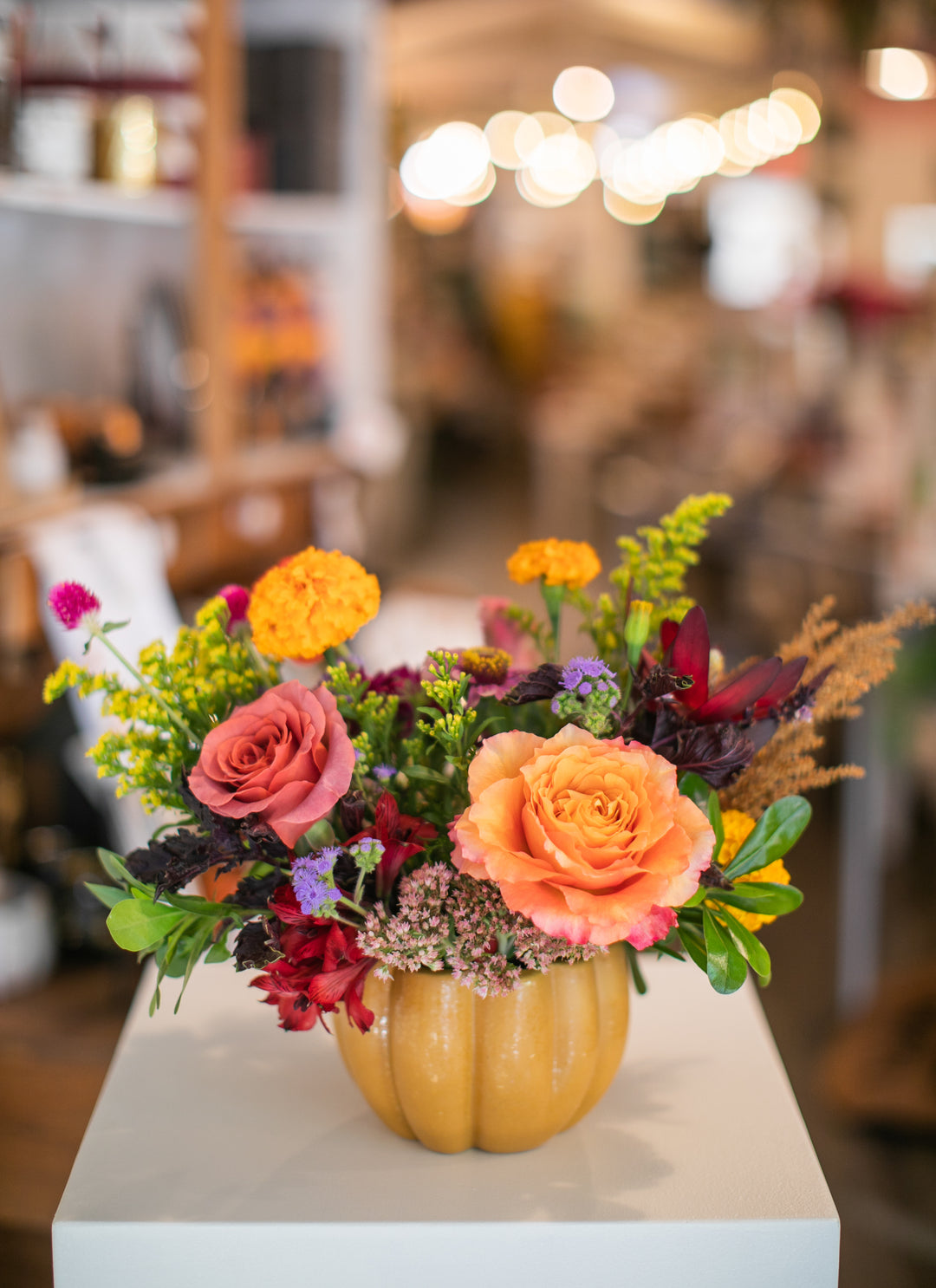 Colorful floral arrangement in a pumpkin-shaped vase Kansas City delivery Thanksgiving Fall flowers