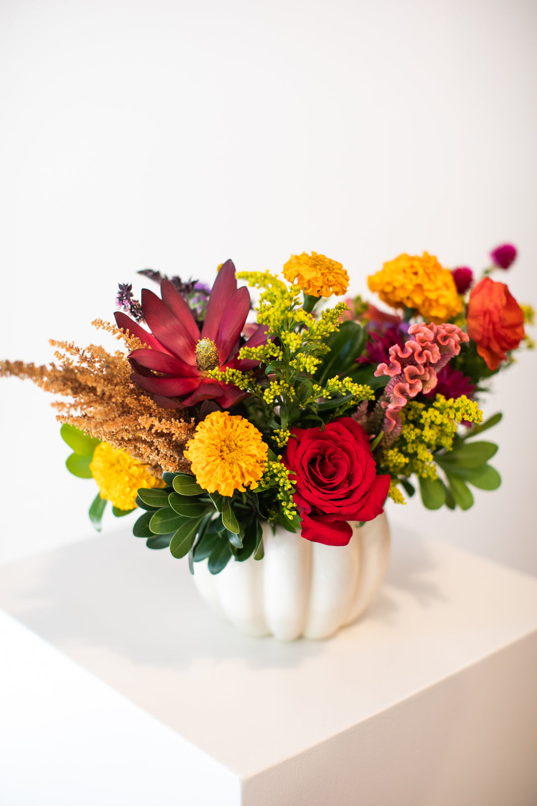 Colorful floral arrangement in a  white pumpkin-shaped vase Kansas City delivery Thanksgiving Fall flowers