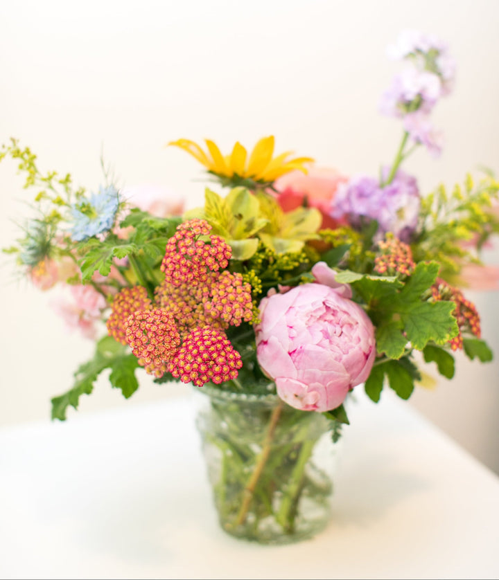 Colorful arrangement in a short glass vase in Kansas City