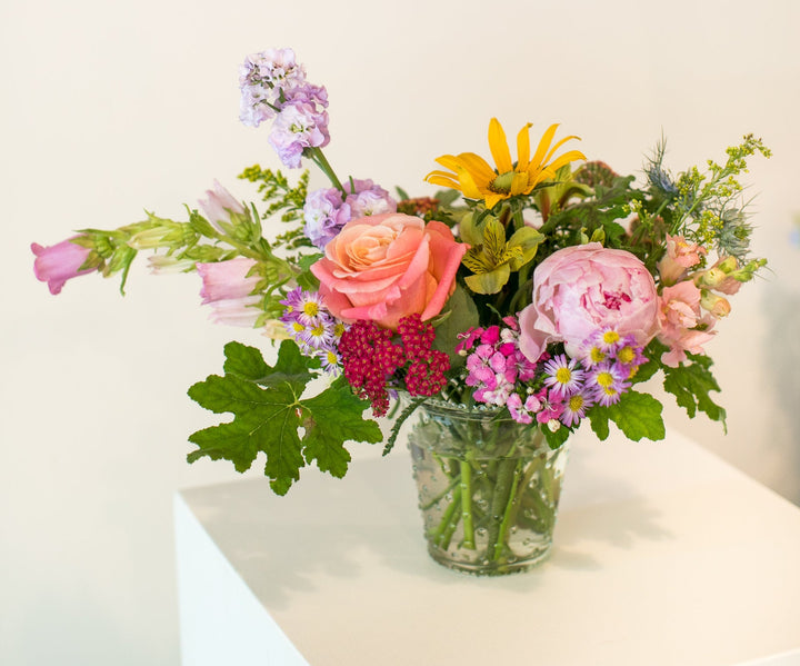 Colorful arrangement in a short glass vase in Kansas City