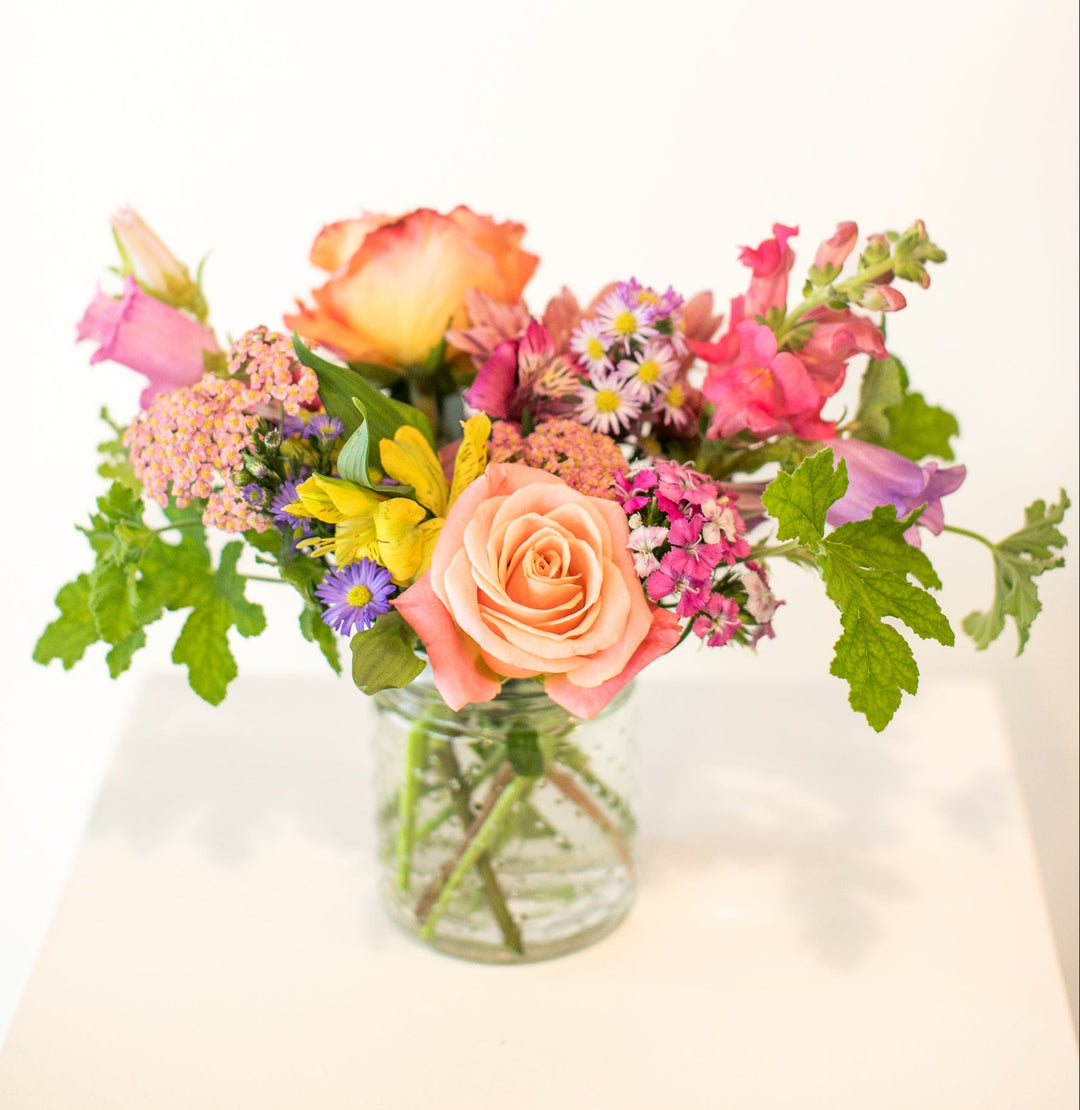 Colorful floral arrangement in a short glass vase in Kansas City