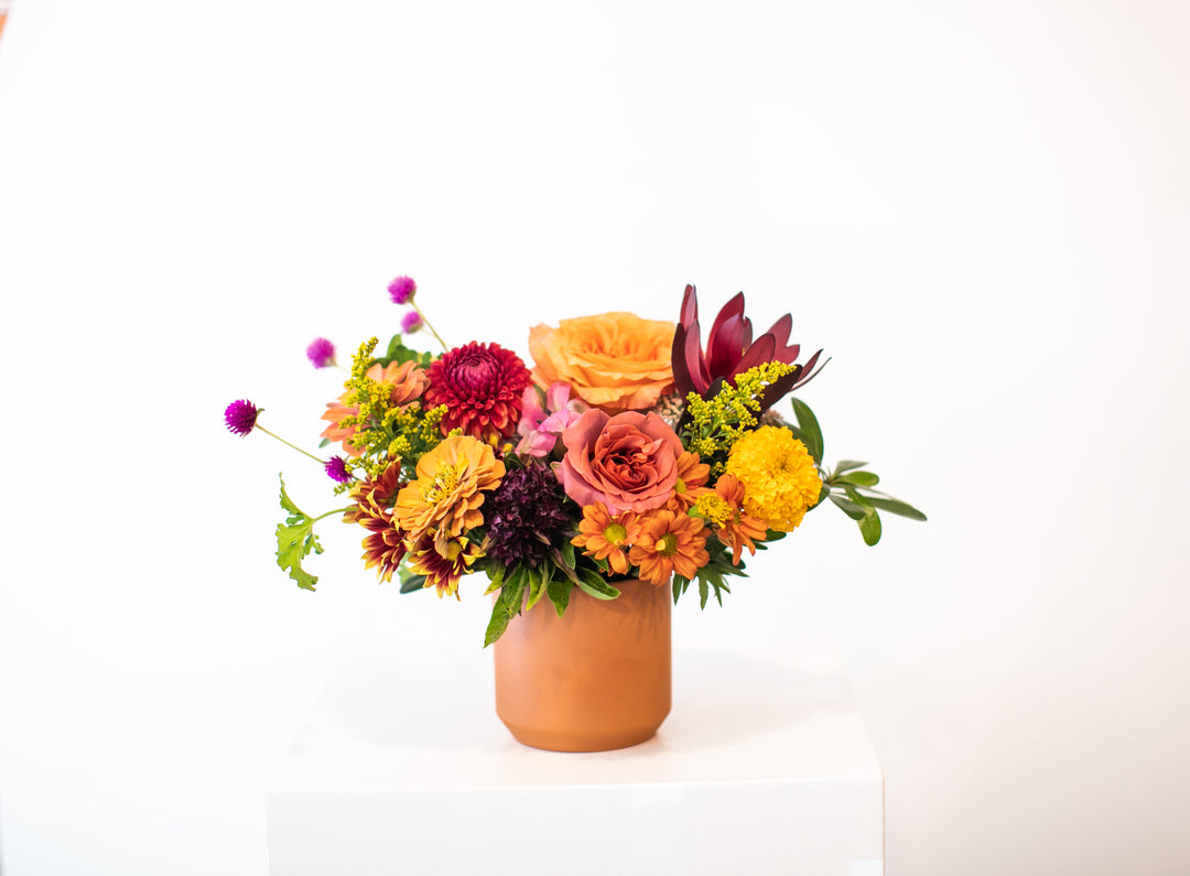 Colorful flower arrangement in a terracotta vase Kansas City Lee's Summit Thanksgiving arrangement