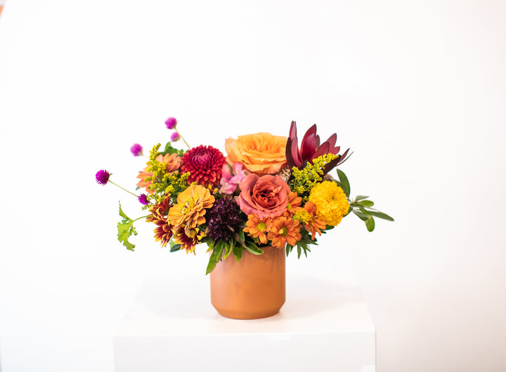 Colorful flower arrangement in a terracotta vase Kansas City Lee's Summit Thanksgiving arrangement