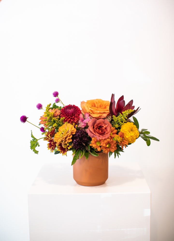 Colorful flower arrangement in a terracotta vase Kansas City Lee's Summit Thanksgiving arrangement