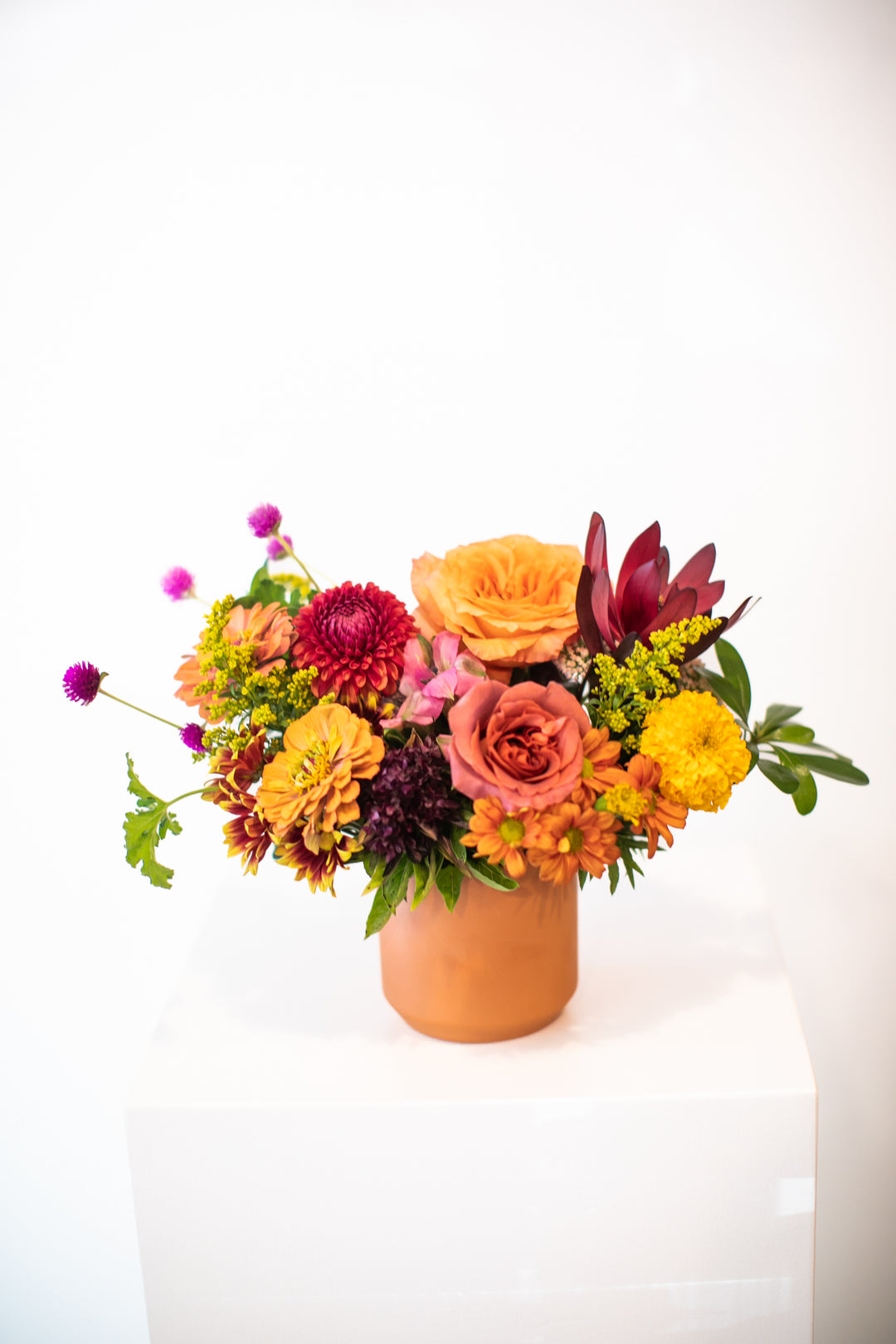 Colorful flower arrangement in a terracotta vase Kansas City Lee's Summit Thanksgiving arrangement
