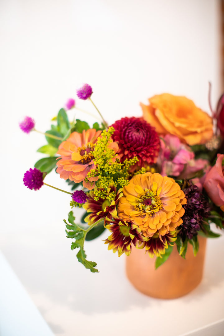 Colorful flower arrangement in a terracotta vase Kansas City Lee's Summit Thanksgiving arrangement