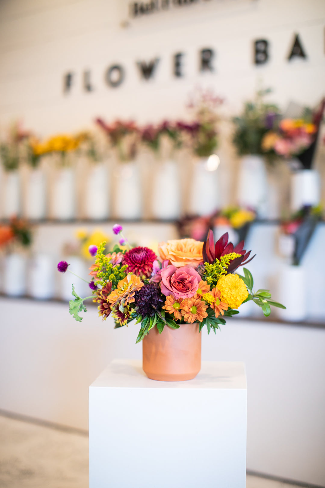 Colorful flower arrangement in a terracotta vase Kansas City Lee's Summit Thanksgiving arrangement