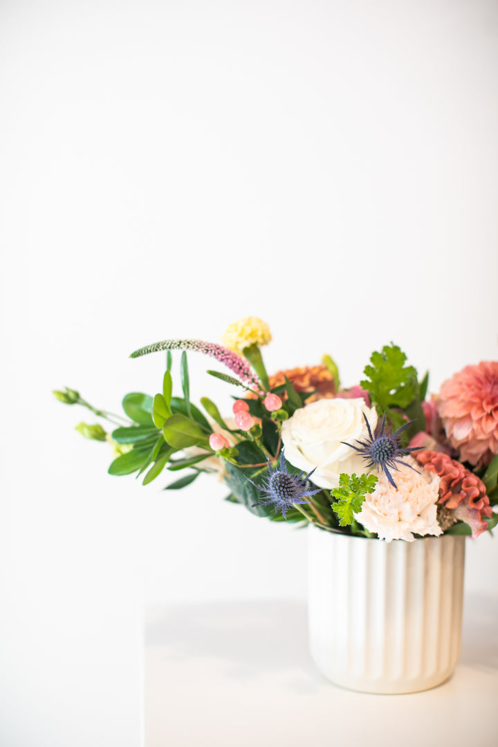 Floral arrangement in a white vase on a light background